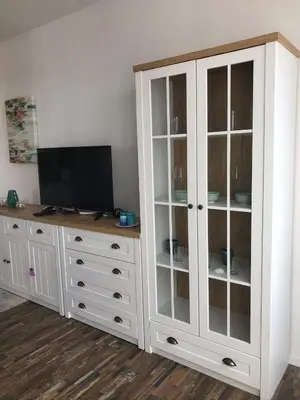 a white cabinet with a television on top of it at Sunny Shore Burgas Apartment in Burgas City