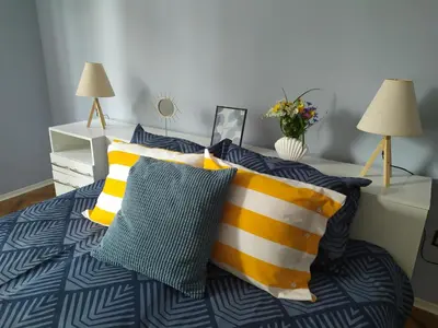 a bedroom with a bed with yellow and blue pillows at Into The BLUE, 4 guests, 5 min away from the BEACH in Varna City