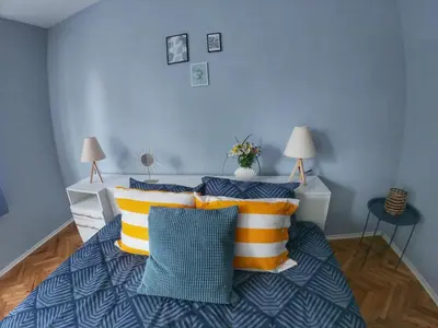 a bedroom with a bed with yellow and blue pillows at Into The BLUE, 4 guests, 5 min away from the BEACH in Varna City
