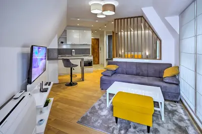 a living room with a couch and a table at Deluxe studio Center city in Varna City