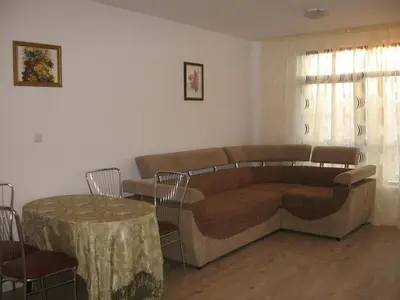 a living room with a couch and a table at Айвазовский парк in Pomorie