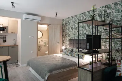 a bedroom with a bed and a television in it at The Cozy Studio, Varna City Centre in Varna City