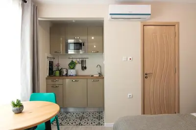 a small kitchen and dining room with a table at The Cozy Studio, Varna City Centre in Varna City