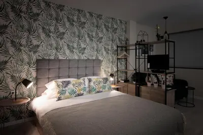 a bedroom with a bed with a floral wallpaper at The Cozy Studio, Varna City Centre in Varna City