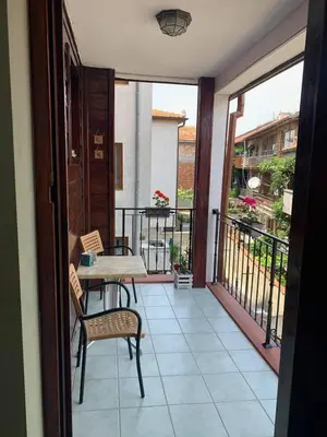 a patio with a table and chairs on a balcony at Boutique House Belevi in Nesebar