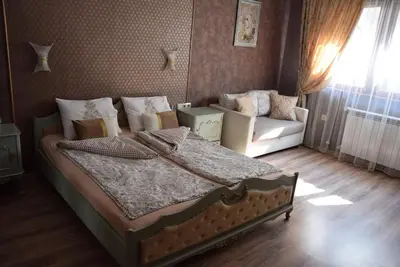 a bedroom with a bed and a couch at Boutique House Belevi in Nesebar