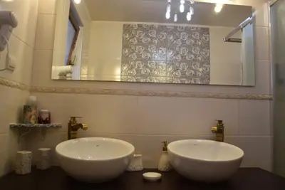 two white sinks in a bathroom with a mirror at Boutique House Belevi in Nesebar