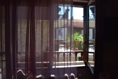 an open window with a view of a house at Boutique House Belevi in Nesebar