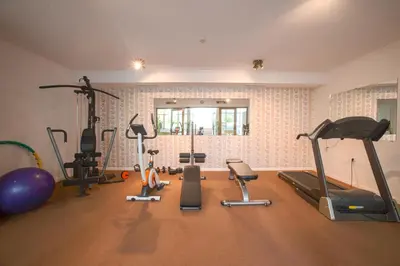 a gym with a bunch of exercise equipment in a room at Dawn Park Deluxe in Sunny Beach