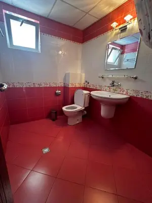 a red bathroom with a toilet and a sink at Хотел БУТИК ИМПЕРИАЛ in Primorsko