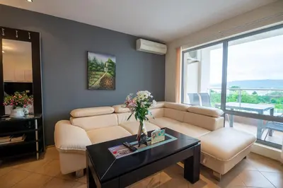 a living room with a couch and a table at Byala Panorama Resort in Byala