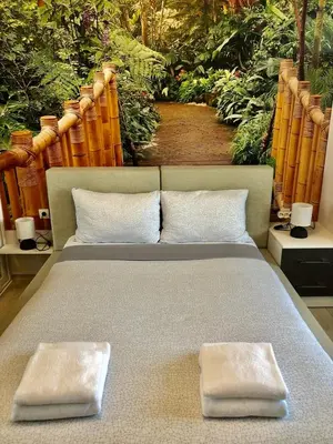 a bed with two pillows on top of it at Avelov Art Apartment in Burgas City