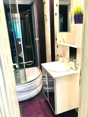 a bathroom with a shower and a sink and a toilet at Avelov Art Apartment in Burgas City