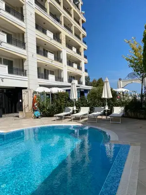 a large swimming pool in front of a building at Private Super apartments by sea in Apart Hotel ! in Pomorie