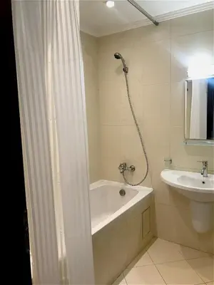 a bathroom with a bath tub and a sink at Private Super apartments by sea in Apart Hotel ! in Pomorie