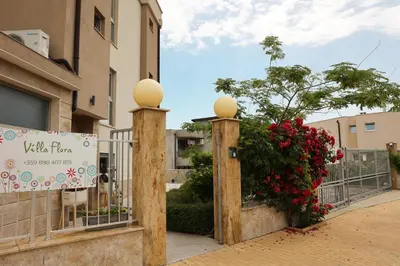 a gate with a sign in front of a building at Villa Flora in Sozopol