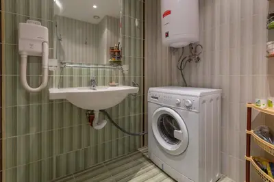 a bathroom with a washing machine and a sink at Avalon appartament da Lary in Sunny Beach