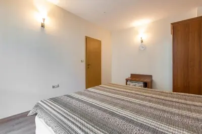 a bedroom with a bed and a wooden door at Avalon appartament da Lary in Sunny Beach