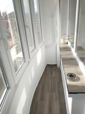 a hallway with two windows and a wooden floor at Варна Хостел in Varna City
