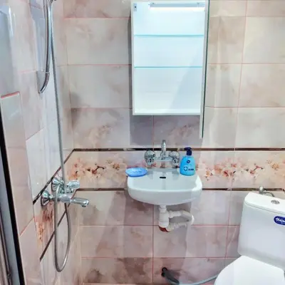 a bathroom with a sink and a shower at Варна Хостел in Varna City