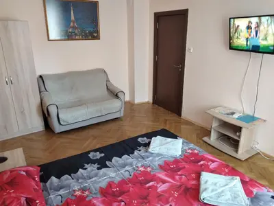 a living room with a couch and a chair at Варна Хостел in Varna City