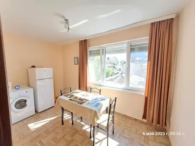 a dining room with a table and a window at Варна Хостел in Varna City