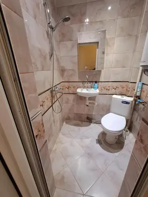 a bathroom with a shower and a toilet and a sink at Варна Хостел in Varna City