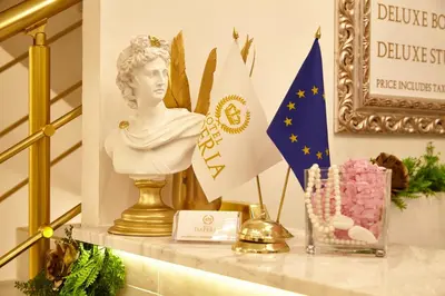 a table with a statue and flags on it at Hotel IMPERIA in Varna City