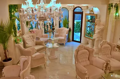 a living room with chairs and a chandelier at Hotel IMPERIA in Varna City