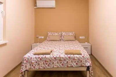 a bedroom with a bed and two night stands at Comfy home in the heart of Burgas in Burgas City
