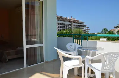 a balcony with a table and chairs on a balcony at Sania in Obzor