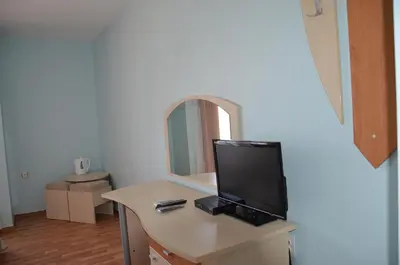 a room with a desk with a tv and a mirror at Sania in Obzor