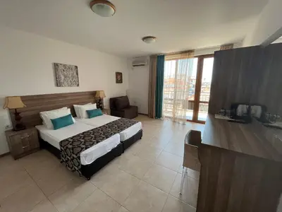 a hotel room with a bed and a desk at Time out in Sozopol