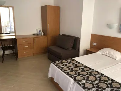 a bedroom with a bed and a chair and a desk at Time out in Sozopol