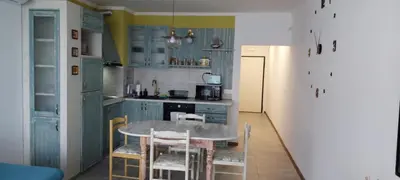 a kitchen with a table and chairs in a room at Anthic 7 Apartment 3 in Sozopol