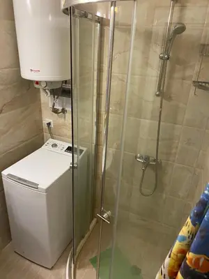 a shower in a bathroom with a washer at Апартамент на солнечном берегу in Sunny Beach