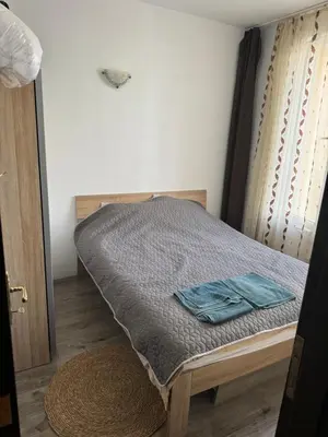 a small bed in a room with a bed sidx sidx sidx at Апартамент на солнечном берегу in Sunny Beach