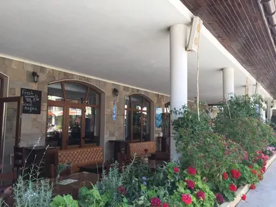 a restaurant with flowers and plants in a building at Hotel Royal Dreams Privat Apartment in Sunny Beach