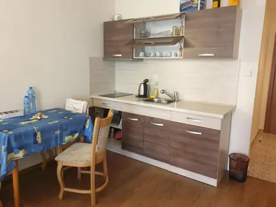 a kitchen with a table and a sink and a table and chairs at Hotel Royal Dreams Privat Apartment in Sunny Beach