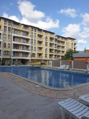 a swimming pool in front of a large building at Hotel Royal Dreams Privat Apartment in Sunny Beach