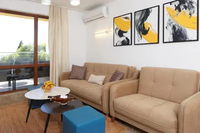 a living room with a couch and a table at Infinity Terrace 1BR Apartment Nessebar in Nesebar