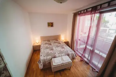 a bedroom with a bed and a large window at Andreya's Sea apartment-Beach, Sea garden ,Old Town, Free Parking, Free EVcharging Station in Varna City