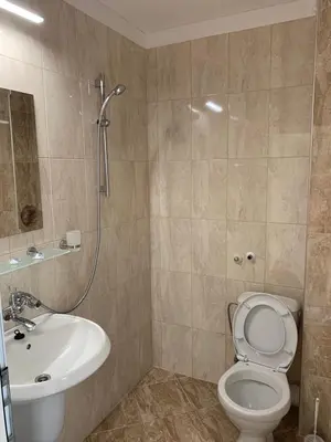 a bathroom with a sink and a toilet and a shower at Guest Rooms Nia Elis Kiten in Burgas City