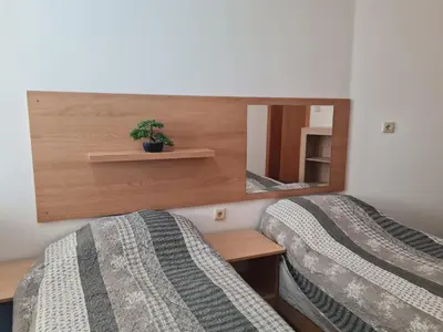 a bedroom with two beds and a mirror at Алми Almi in Sveti Vlas