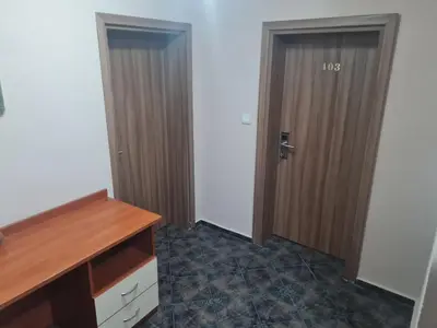 a room with a wooden door and a desk at Алми Almi in Sveti Vlas