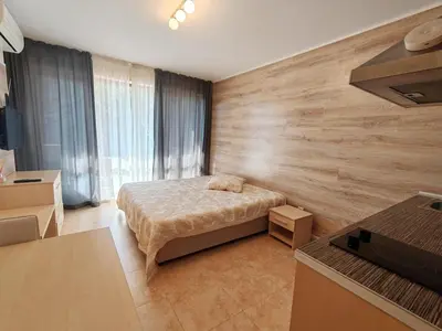 a bedroom with a bed and a wooden wall at River park in Sunny Beach