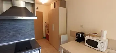 a kitchen with a microwave and a stove top oven at River park in Sunny Beach