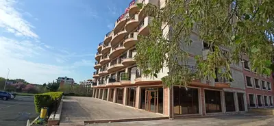 a building with a tree in front of it at River park in Sunny Beach