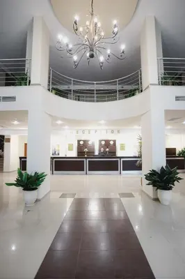a lobby with a chandelier in a building at Sun Palace Hotel - All Inclusive in Sunny Beach