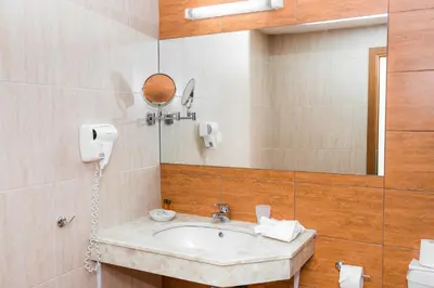 a bathroom with a sink and a mirror at Sun Palace Hotel - All Inclusive in Sunny Beach